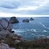 A series of low sea stacks off a rocky coast